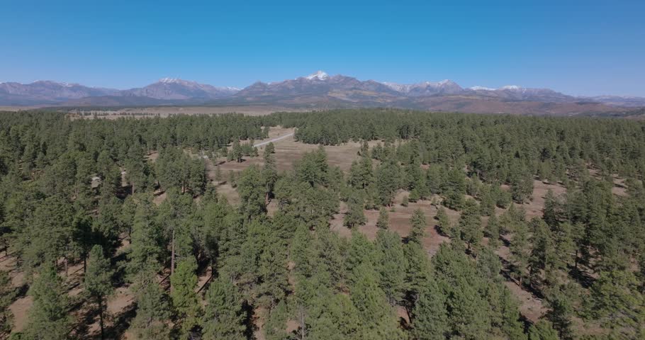 A serene aerial view of Pagosa Springs, Colorado, featuring pine forests and mountains