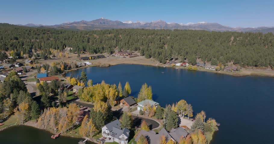 A serene lake surrounded by colorful autumn trees in pagosa springs, colorado, aerial view