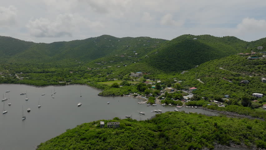 Aerial Forward Scenic View Of Nautical Vessels At Island Under Clouds - VI, Saint John, United States of America