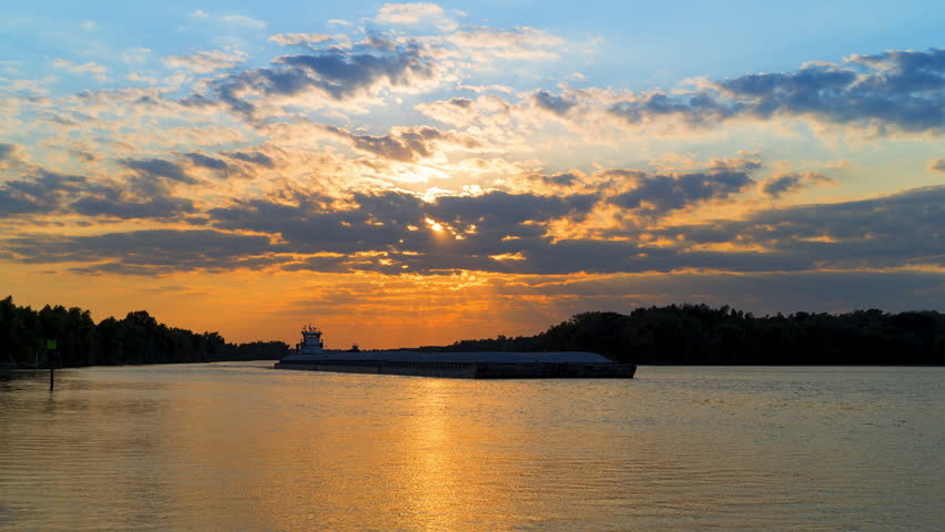 Lockdown Time Lapse Shot Of Barges Moving On Rippled Sea Under Clouds In Dramatic Sky During Sunset - Arley, Alabama