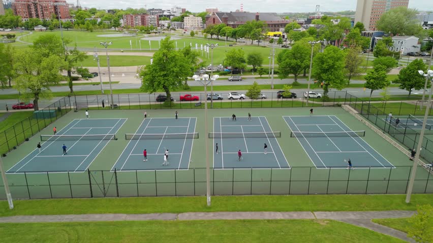 Aerial View Of Tennis Players Engaged In A Match On Courts In Downtown Halifax, Nova Scotia. The Bright Summer Day And Urban Setting Provide A Perfect Scene For Sports Or Lifestyle Content.