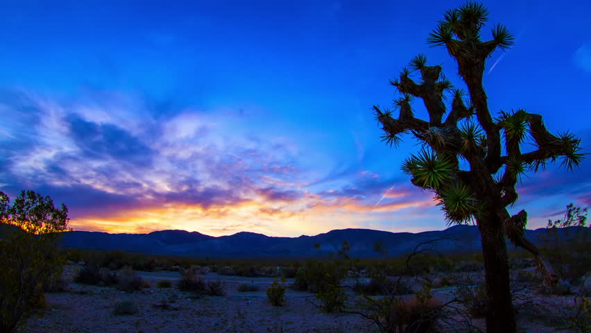 Lockdown Time Lapse Shot Of Semi Arid Desert And Mountains Under Dramatic Clouds In Sky From Sunset To Night - Joshua Tree National Park, California