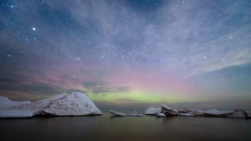 Scenic timelapse. Star trails above the sea with melting ice floes.