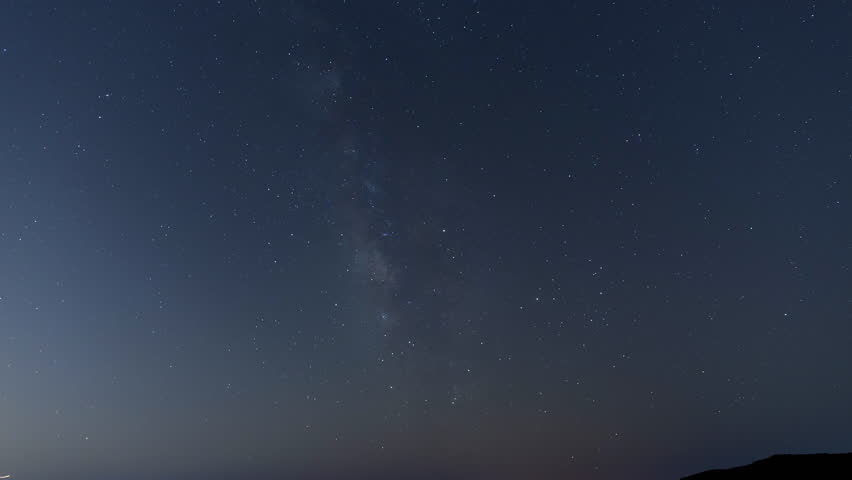 Time Lapse Shot Of Illuminated Roads Amidst Silhouette Mountains Under Stars In Sky - Big Pine, California