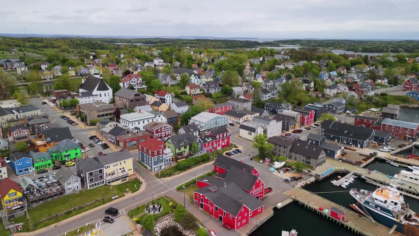 Aerial Footage Of Lunenburg, Nova Scotia, Capturing The Historic Town On A Cloudy Summer Day. The Beautiful Coastal Setting, Colorful Buildings, And Rich History Make This A Perfect Visual.