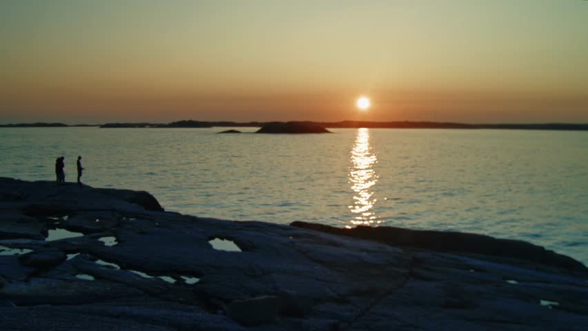 A Stunning Ocean Sunset Over The Hills And Islands Of Nova Scotia, Canada. The Warm Glow Of The Setting Sun Illuminates The Atlantic Ocean, Creating A Peaceful Scene On A Summer Evening.