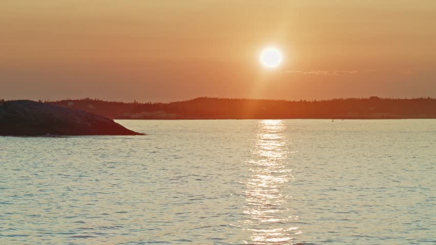 A Beautiful Sunset Over An Atlantic Ocean Bay In Nova Scotia. The Peaceful Summer Evening With Rolling Hills And Islands Creates A Serene And Majestic Scene Perfect For Travel And Nature Themes.