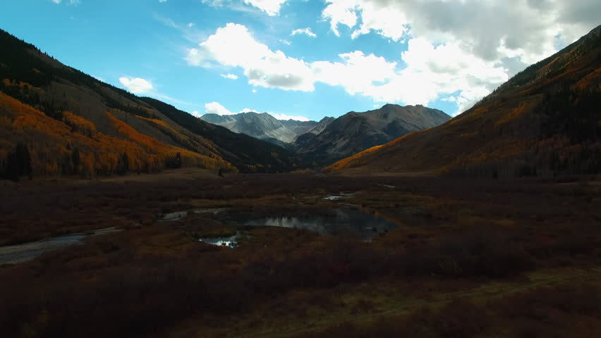Aerial Beautiful Shot Of Elk Mountains In National Park, Drone Flying Forward Over Ponds On Landscape - CO, Colorado Springs, United States of America