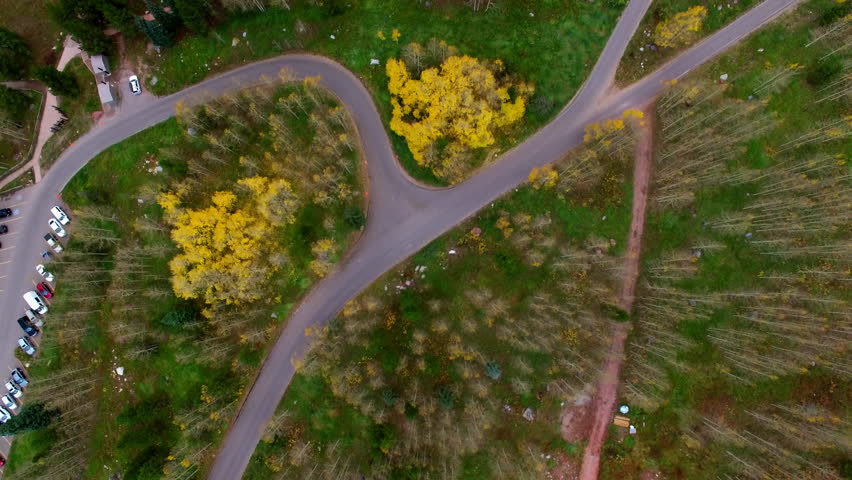 Aerial Top Forward Tilt Up Shot Of Cars Parked In Tranquil National Park - CO, Colorado Springs, United States of America