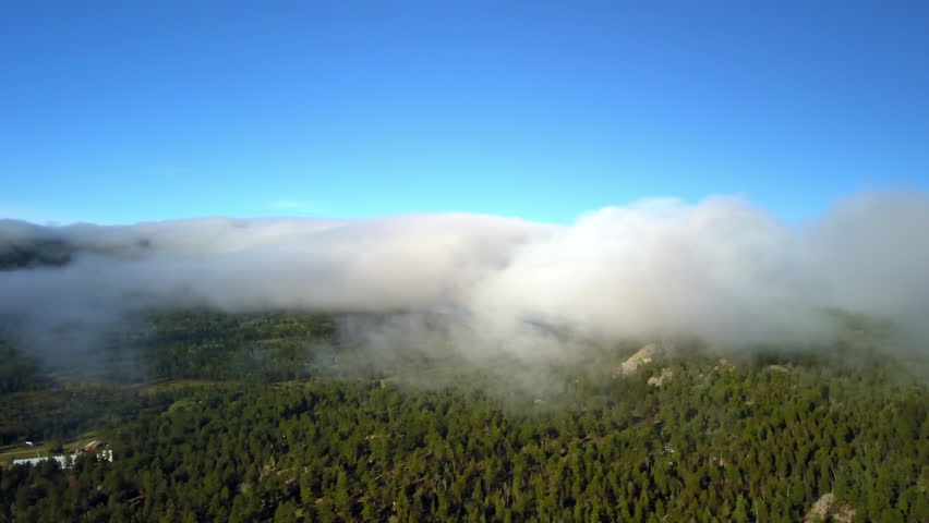 Aerial Panning Shot Of Clouds Moving Over Green Jungle On Mountains During Sunny Day - CO, Colorado Springs, United States of America