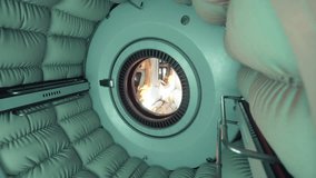 The interior of a space station showcases padded walls and a circular window revealing an astronaut conducting activities in low Earth orbit. The environment is futuristic and functional. - Powered by Shutterstock - Get 15% off with code: PIKWIZARD15