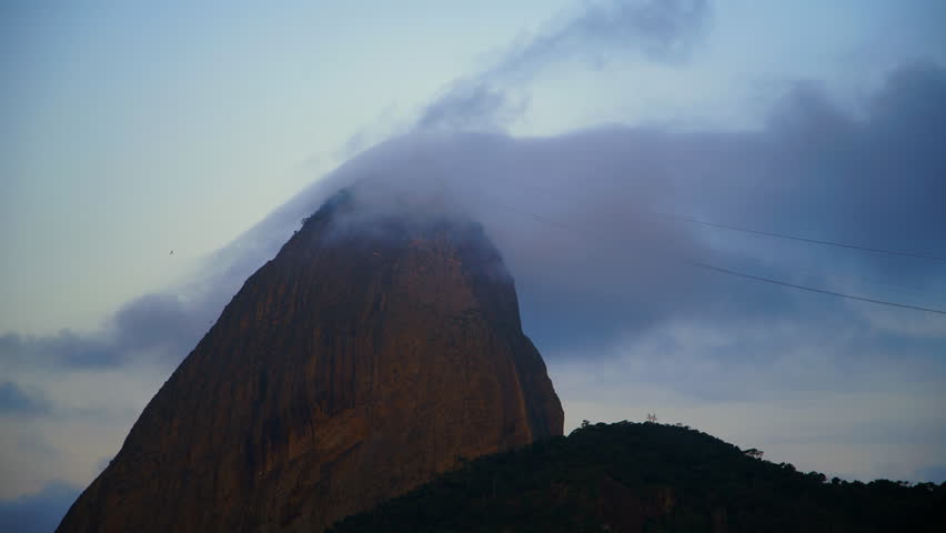 Lockdown Shot Of Sugarloaf Peak Under Clouds In Sky - Rio de Janeiro, Brazil
