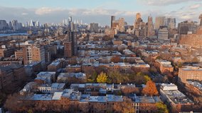 Aerial view of low rise residential buildings and colorful autumn trees in Brooklyn with Manhattan skyline in the background - Powered by Shutterstock - Get 15% off with code: PIKWIZARD15
