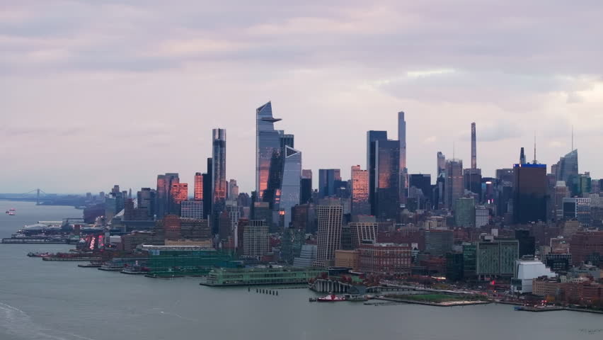 Hudson Yards skyline bathed in golden light, skyscrapers gleaming in Midtown Manhattan, financial district panorama revealing architectural brilliance