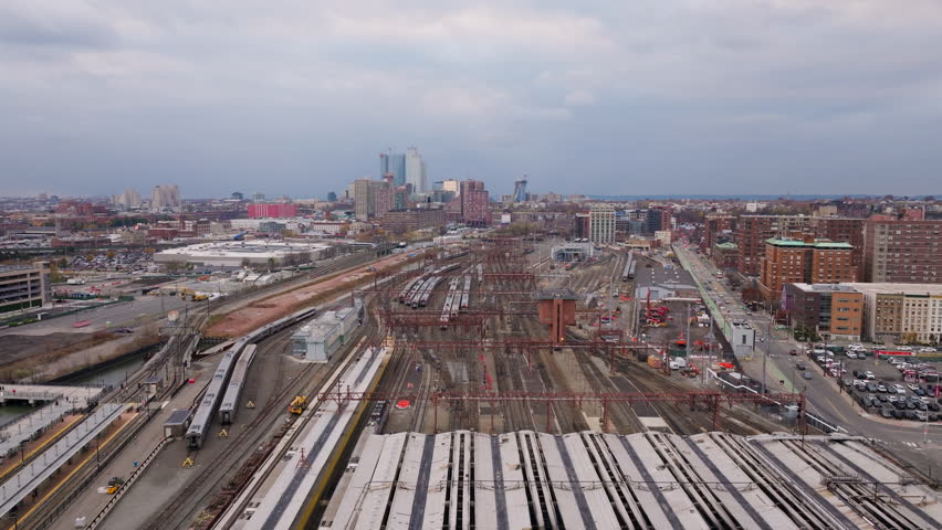 Aerial view of trains at Hoboken Terminal a major railroad yard, located in New Jersey, in front of the city of New York