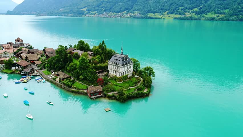 White island villa, Iseltwald on blue Lake Brienz, Switzerland, Drone, Summer