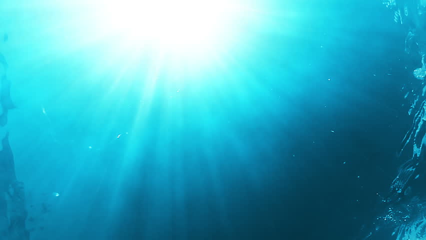 The underwater camera. View of the bright sun through the water column. Surf