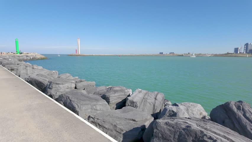 Ostend, West-Flanders, Belgium, 6th of October, 2024, Experience the serene coastal view with charming lighthouses and turquoise waters under a clear blue sky