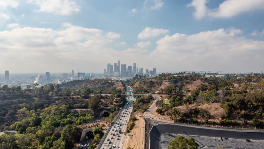 A Bustling Freeway Runs Through Hills And Neighborhoods, Leading To A Sprawling Downtown Skyline - Los Angeles, California