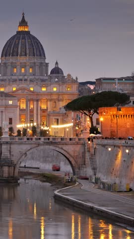 Stunning view of Vatican City at twilight showcasing St. Peter's Basilica and the illuminated bridge. Rome, Italy. Vertical shot