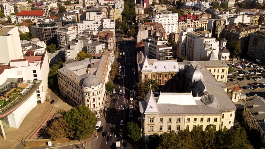 Aerial Shot Of Residential Buildings On City Landscape, Drone Flying Forward Over Cars Moving Over Roads During Sunny Day - Bucharest, Romania