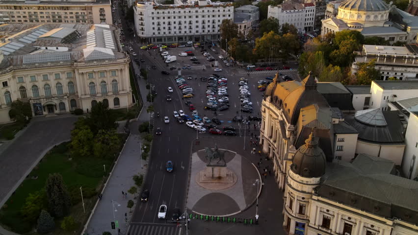 Aerial Backward Shot Of Cars Moving On Roads Amidst Buildings In City - Bucharest, Romania