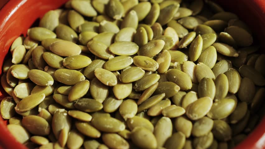 Pumpkin seeds close-up. Healthy vegetarian snack. High quality 4k footage
