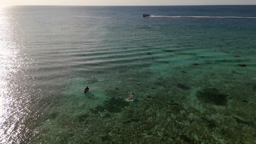 Swimming at sunset, aerial view from the beach, Caribbean Sea