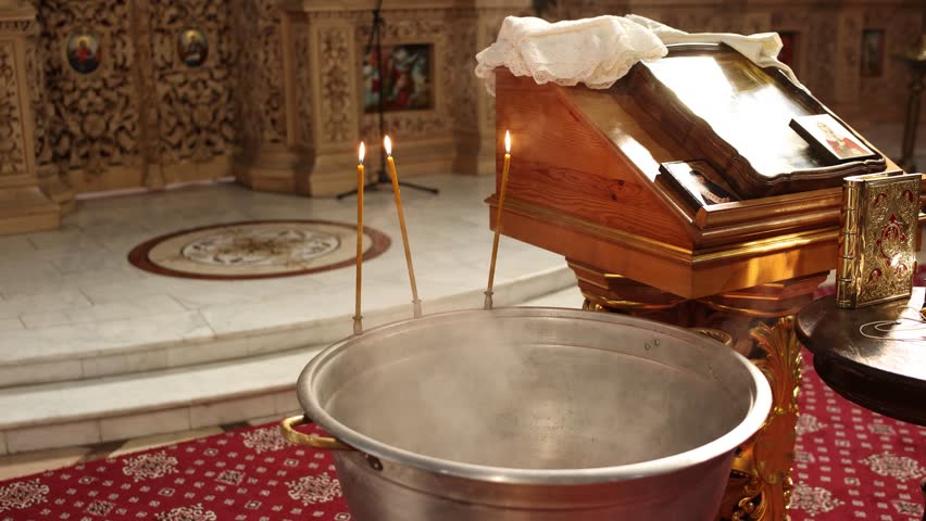 baptismal font with candles on it in an Orthodox church