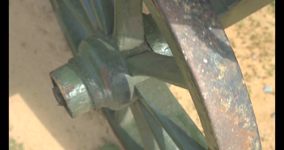 Country horse carriage used in the 19th century. The cart for agricultural work. Vintage wagon wooden wheel in green grass. 
