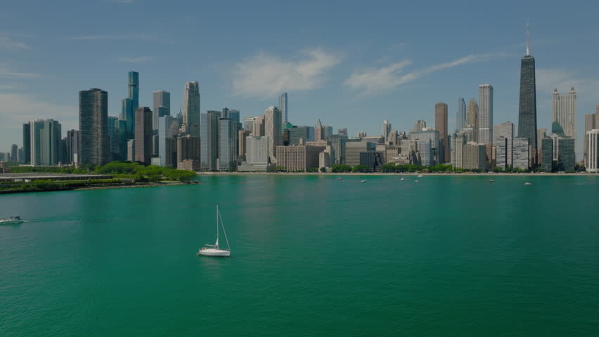 Aerial Panning Shot Of Famous Public Park In Modern City, Drone Flying Over Lake On Sunny Day - Chicago, Illinois