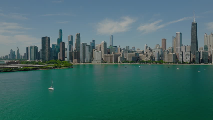 Aerial Panning Shot Of Milton Lee Olive Park In Modern City, Drone Flying Over Lake Michigan On Sunny Day - Chicago, Illinois