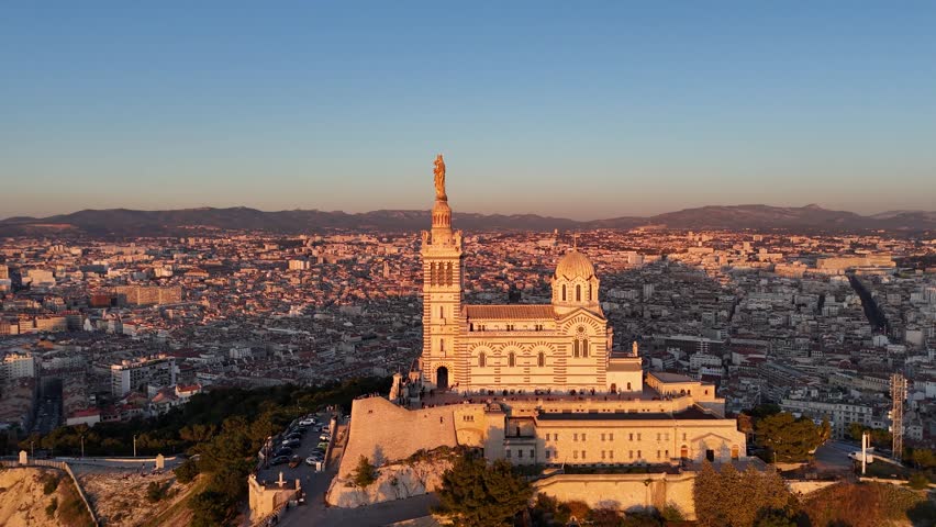 Aerial cityscape view of Marseille during sunset , Drone fly close to Notre-Dame de la Garde Catholic basilica