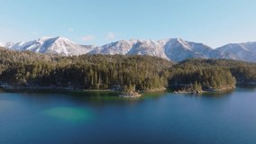 Turquoise lake Eibsee at the base of mountain Zugspitze in winter, Bavaria, Drone shot - Powered by Shutterstock - Get 15% off with code: PIKWIZARD15