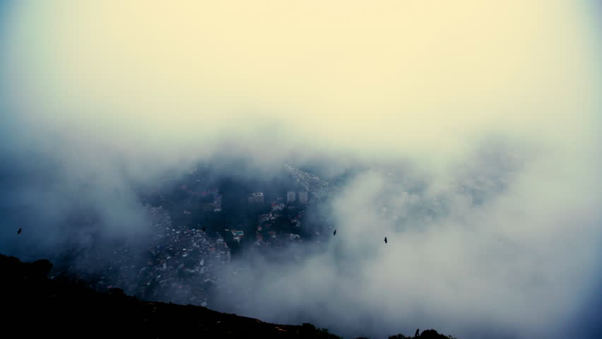 Aerial Lockdown Shot Of Birds Flying Amidst Clouds Moving Over City Seen From Mountain - Rio de Janeiro, Brazil