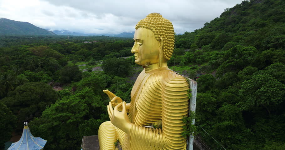 Golden Buddha Statue At Dambulla Golden Temple In Sri Lanka. - aerial shot