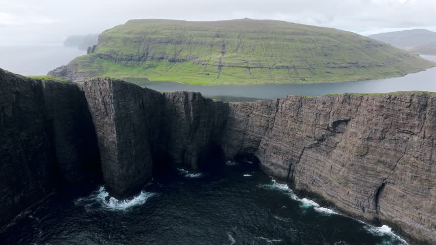 Stunning cliffside lake view near Leitisvatn Sørvágsvatn, Faroe Islands, cloudy day
