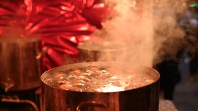 Hot, steaming mulled wine simmers in a large pot at a Christmas market in Rouen, France - Powered by Shutterstock - Get 15% off with code: PIKWIZARD15