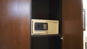 Open Wooden Wardrobe Displaying Secure Electronic Safe for Valuables in Modern Hotel Room. - Powered by Shutterstock - Get 15% off with code: PIKWIZARD15