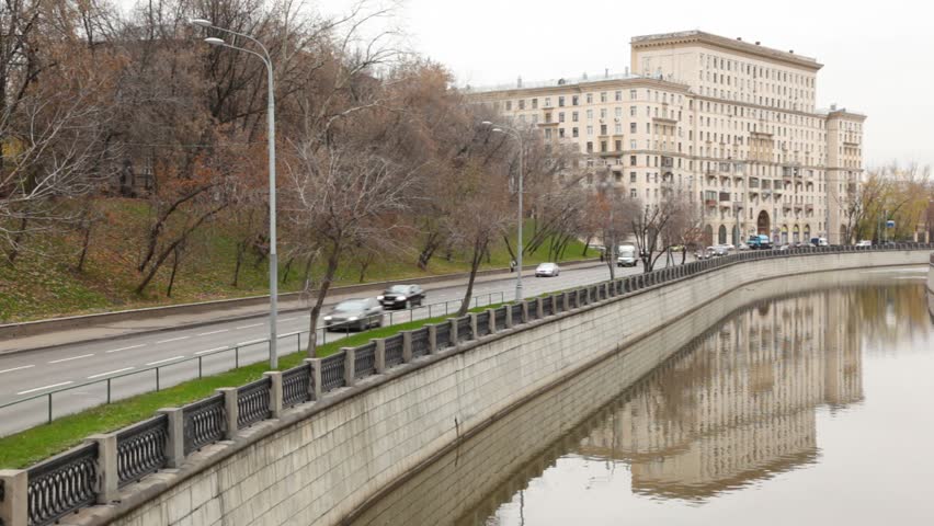 Car traffic on the road near the river during the day