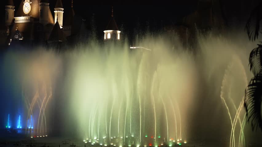 A mesmerizing musical fountain show with vibrant blue and red lights at Vinpearl, Nha Trang, creating a magical nighttime experience.