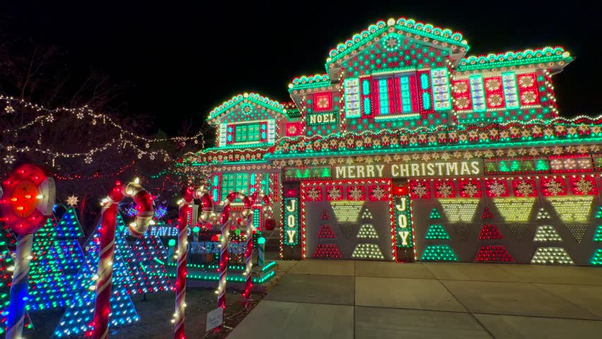 Gingerbread Candy cane lane house vibrant lights home Merry Christmas trees Happy Holidays decoration Highlands Ranch Denver Colorado USA night time bright hanging home neighborhood static shot