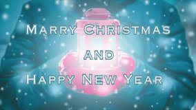 Merry Christmas and Happy New Year words design. Woman in jacket and red gloves holding red lantern candlestick with light coming out during snowfall in winter. Loop seamless animation text background - Powered by Shutterstock - Get 15% off with code: PIKWIZARD15