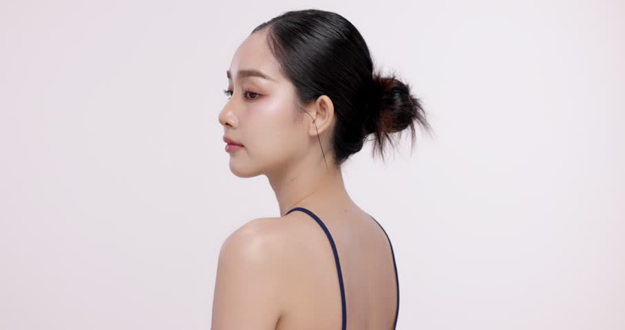 Slow motion of beautiful young Asian girl with k-beauty make up style on isolated white background for commercial beauty advertising.