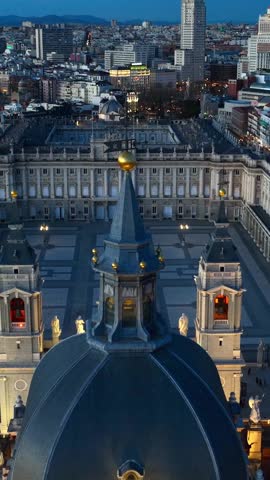 vertical video: downtown Madrid at night with night illumination, drone view of cathedral of Madrid and Madrid royal palace in the evening, Palacio Real de Madrid in the capital of Spain. 