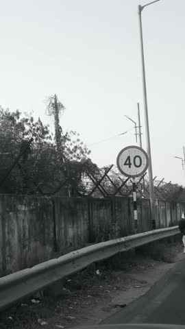 Foggy road sign of 40 crossing through the city with trees and green surroundings