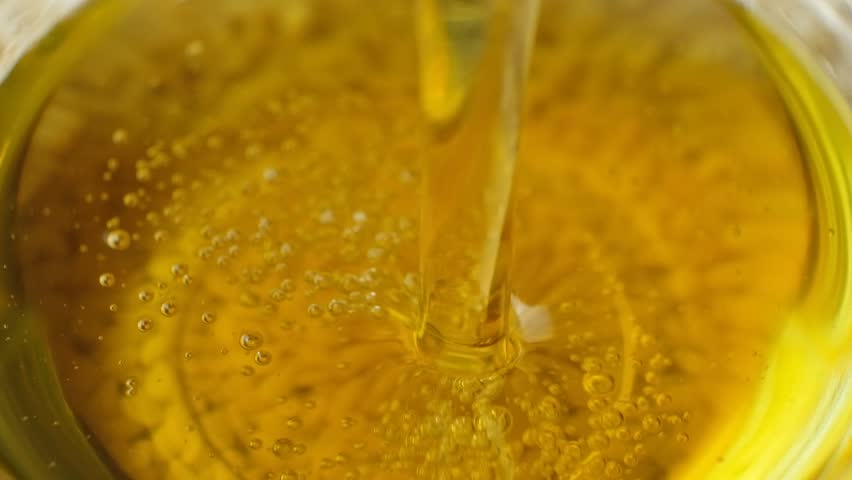 Natural Unrefined Vegetable Oil Pouring, Oil Bubbles, Macro Slow Motion.