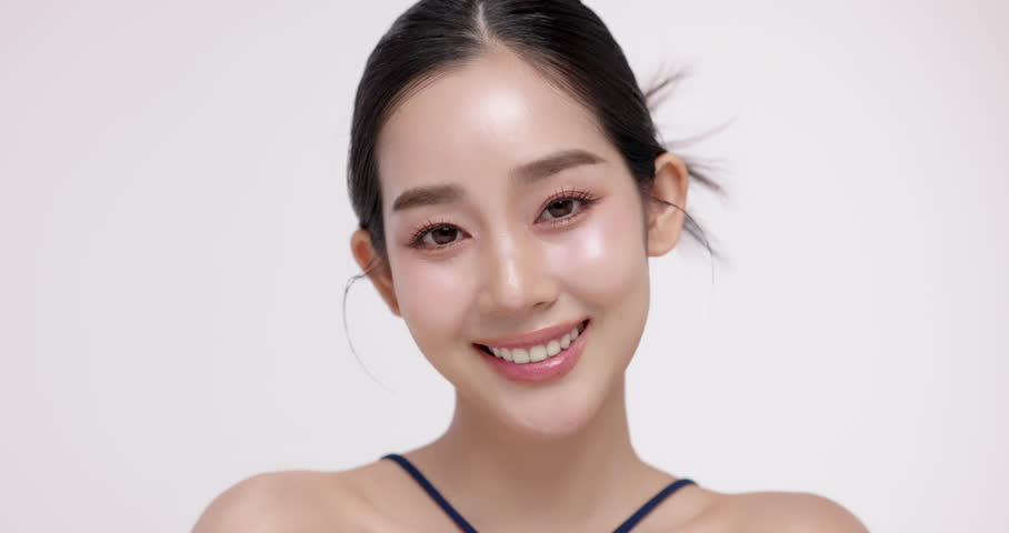 Slow motion of beautiful young Asian girl with k-beauty make up style on isolated white background for commercial beauty advertising.