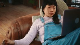 Annoyed Japanese woman arguing and having disagreements during business video call from home on laptop. - Powered by Shutterstock - Get 15% off with code: PIKWIZARD15