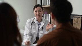 Professional female physician offering compassionate medical guidance, discussing health concerns with young couple during detailed consultation in modern hospital setting - Powered by Shutterstock - Get 15% off with code: PIKWIZARD15